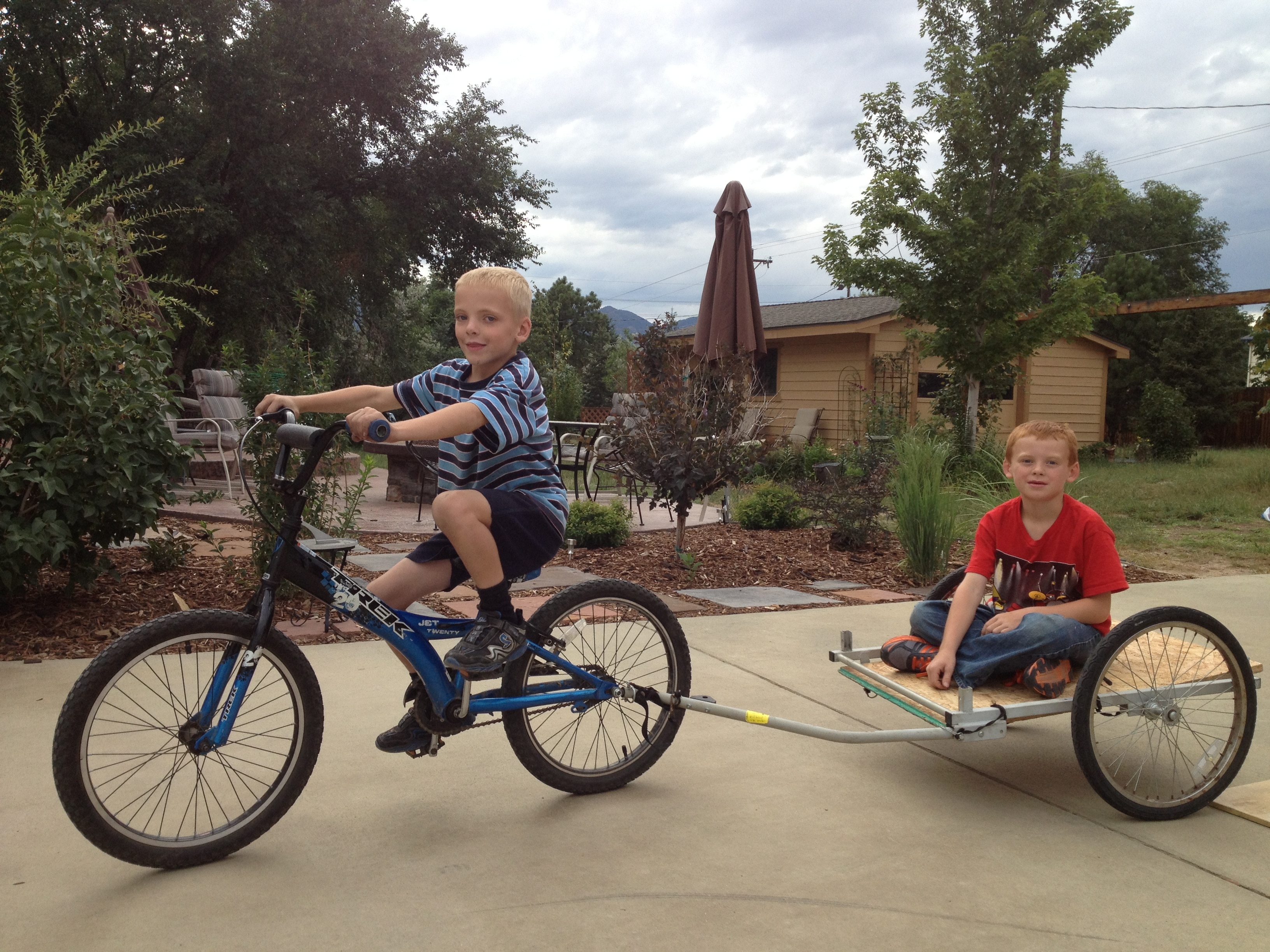 Brad Lovell's sons play on a bicycle and trailer as kids.